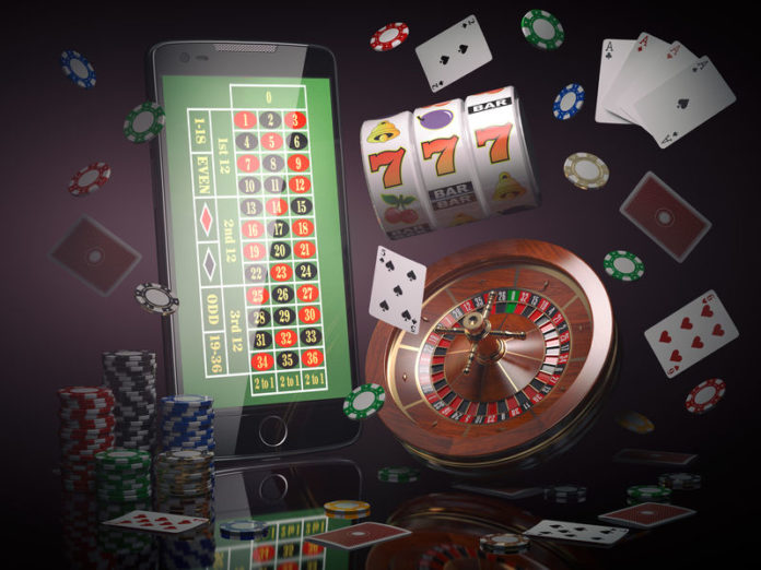 Online casino concept. Mobile phone, roulette with casino chips,
